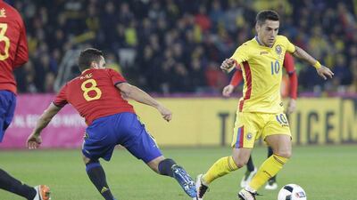 Romania's Claudiu Stanciu, left, and Spain's Koke in action during their international friendly. REUTERS