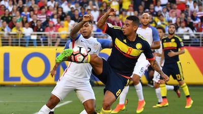 USA’s DeAndre Yedlin, left, and Colombia’s Edwin Cardona vie for the ball. Josh Edelson / AFP
