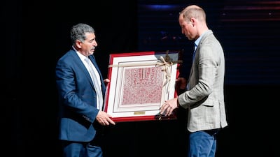 Britain's Prince William receives a gift from Musa Hadid, the mayor of Ramallah, at a reception during his visit to the West Bank city's municipality. The Duke of Cambridge is the first member of the royal family to make an official visit to the Jewish state and the Palestinian territories. Abbas Momani / AFP
