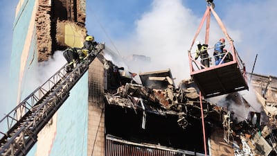 Rescue workers at a residential building heavily damaged by a Russian strike on Ternopil, Ukraine. AP