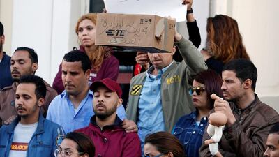People take part in a protest after 11 babies mysteriously died in a hospital in Tunis, Tunisia. The wording on the box reads: 'A gift for the Minister of Health''. Reuters