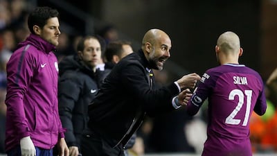 Pep Guardiola, centre, will be forced to focus on the treble, and no longer the quadruple. Andrew Yates / Reuters