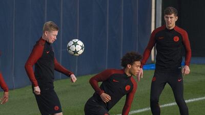 Manchester City’s Kevin De Bruyne, left, John Stones, right, and Leroy Sane, centre, attend training. Peter Powell / EPA