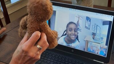 A woman shows Naomi the teddy bear she lost a year earlier.