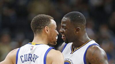 Stephen Curry and Draymond Green of the Golden States Warriors celebrate after they defeated the San Antonio Spurs at AT&T Center on April 10, 2016 in San Antonio, Texas. The Warriors won 90-86, tying the all-time record for wins in a season with 72. Ronald Cortes/Getty Images/AFP