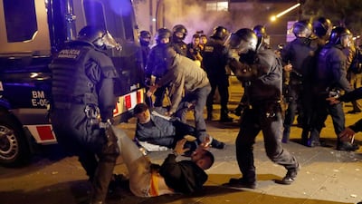 Police arrest a protester in the surroundings of Camp Nou stadium. EPA