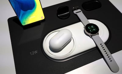 Samsung's Galaxy Active smart watch and Galaxy Buds wireless head phones are displayed near a Galaxy S10 smartphone at the company’s previous Unpacked event. Reuters