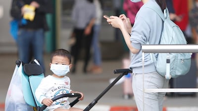 Passengers wear masks amid fear of a coronavirus outbreak, as they arrive at Phnom Penh International Airport in Phnom Penh, Cambodia. EPA