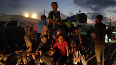 Displaced Palestinians leave an area in east Khan Younis after the Israeli army issued an evacuation order for parts of the city in the southern Gaza Strip on Monday. AFP