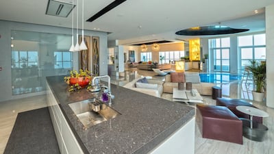 The open-plan, modern kitchen looks out across the pool. Courtesy Allsopp and Allsopp