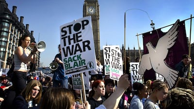 Anti-war demonstrators stage a sit-down protest outside the Houses of Parliament