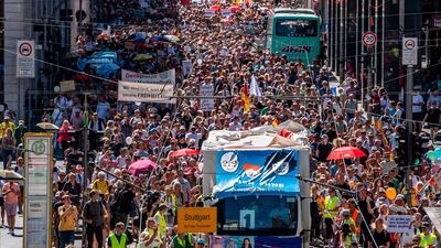 Thousands of demonstrators march down the Friedrichstrasse street as they take part in a demonstration by the initiative 'Querdenken-711' with the slogan 'the end of the pandemic-the day of freedom' to protest against the current measures to curb the spread of the Coronavirus, in Berlin. AFP