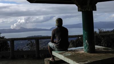 A man looks at the errupting Taal Volcano from a park in Tagaytay City, Philippines. Reuters