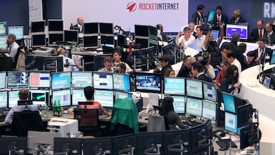 Brokers work during the IPO of German startup company Rocket Internet at the stock exchange in Frankfurt, Germany. Naspers has bought half of Rocket's stake in Delivery Hero. AFP / Daniel Roland
