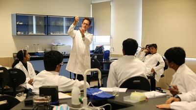 Sebastian Kraves, one of the miniPCR co-founders, shows students how to test food for bacterial contamination through DNA analysis during the Genes in Space workshop.