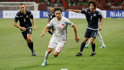 China's Wu Xinghan fights for the ball during the 2022 World Cup football qualifier against Guam in Suzhou. AFP