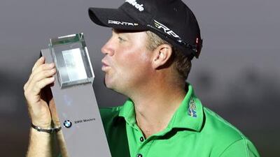 Swedish golfer Peter Hanson celebrates with the BMW Masters trophy after his victory in Shanghai