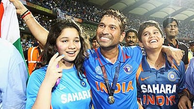After celebrating India’s World Cup victory on the field with his daughter, Sara, left, and his son, Arjun, right, Sachin Tendulkar says he’s having too much fun to retire.
