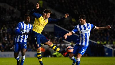 Olivier Giroud of Arsenal controls the ball under pressure from Gordon Greer of Brighton during their FA Cup fourth round match on Sunday. Mike Hewitt / Getty Images