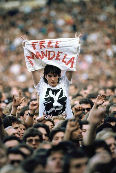A woman holds a banner saying 'Free Mandela' during the 'Human Rights Now!' concert, in aid of Amnesty International, held at Wembley Stadium on September 2, 1988 in London, England. Georges De Keerle / Getty Images