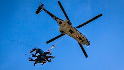 A Super Puma helicopter of the Swiss Air Force carries three horses during a veterinary emergency exercise in Saignelegier, Switzerland. AP
