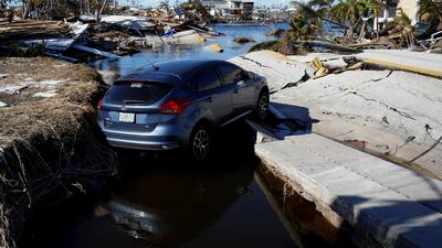 A car on a destroyed road between Matlacha and Pine Island after Hurricane Ian. Reuters