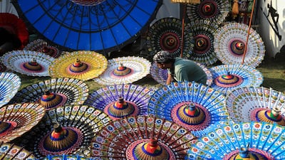 A craftsman makes traditional parasols from cloth and bamboo during the Indonesia Parasol Festival in Solo, Central Java, on Friday. AFP