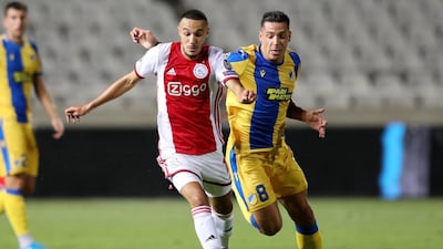 APOEL Nicosia's Lucas Souza fights for the ball against Ajax Amsterdam's Noussair Mazraoui. EPA