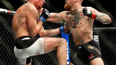 In this Saturday, March 5, 2016 file photo, Conor McGregor, right, trades punches with Nate Diaz during their UFC 196 welterweight mixed martial arts match in Las Vegas. One of the UFC’s top draws, McGregor created a stir Tuesday, April 19, 2016 when he tweeted that retirement was on the horizon. (AP Photo/Eric Jamison, File)