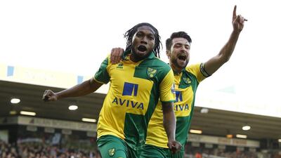Norwich City’s Dieumerci Mbokani celebrates scoring against Liverpool on Saturday with teammate Russell Martin.