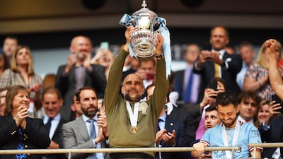 Pep Guardiola holds up the FA Cup following Manchester City's 2-1 win over Manchester United in the final at Wembley on June 3, 2023, in London, England. Getty Images