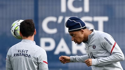 Paris Saint-Germain's French forward Kylian Mbappe (R) heads the ball during a training session at the club's Camp des Loges training ground in Saint-Germain-en-Laye, west of Paris, on April 28, 2022. (Photo by FRANCK FIFE / AFP)
