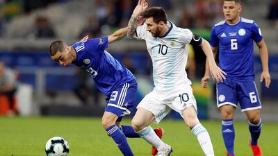 Argentina's Lionel Messi, centre, in action against Paraguay's Miguel Almiron. EPA