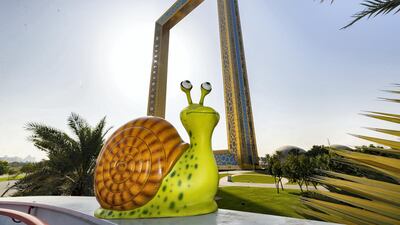 Freddie the snail sits in front of the Dubai frame. Chris Whiteoak / The National