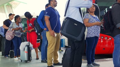 UAE residents line up at the bus terminal in Abu Dhabi waiting for buses to Dubai as they head out of town as the EID holiday weekend starts;Delores Johnson;/ The National
