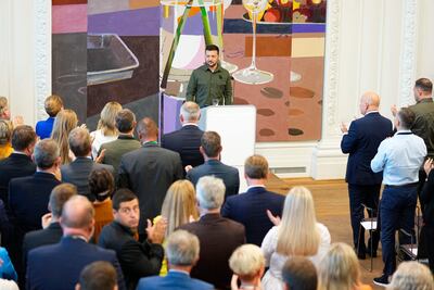 Ukrainian President Volodymyr Zelensky and his wife Olena Zelenska receive a standing ovation by members of parliament upon arrival at the Danish Parliament. AFP