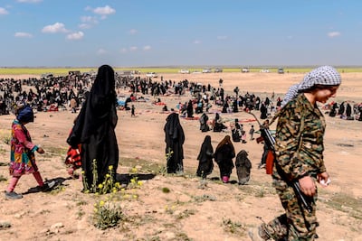 Women and children evacuated from the ISIS holdout of Baghouz arrive at a screening area held by the Kurdish-led Syrian Democratic Forces in Deir Ezzor last year. AFP