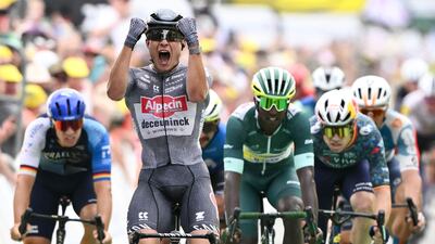 Alpecin-Deceuninck rider Jasper Philipsen crosses the finish line to win Stage 10 of the Tour de France ahead of second-placed Biniam Girmay, in the sprint leader's green jersey, on July 9, 2024. AFP