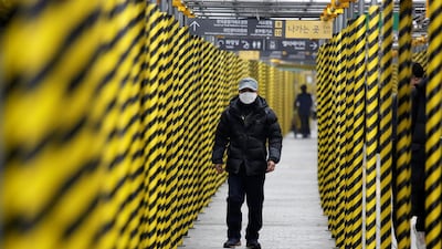 A man wearing a mask as a preventive measure against the coronavirus?walks at a subway station in Seoul, South Korea, February 20, 2020. REUTERS/Heo Ran