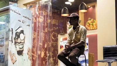 A worker waits for cars to pull up outside the Teapot cafe. Chris Whiteoak / The National