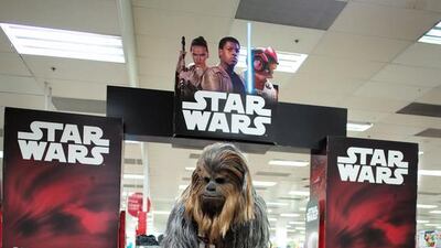 A fan dressed as Chewbacca shops for merchandise. Jason Reed / Reuters