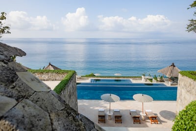 Amankila's three-tier infinity pool cascades down the hillside towards the Lombok Strait, becoming one of Bali's most photographed hotel landmarks. Photo: Aman