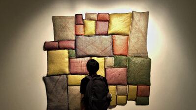 A visitor in front of Ashfika Rahman's work at Dhaka Art Summit. Alexandra Chaves / The National