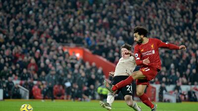 Mohamed Salah tucks his shot away after being set clear by Alisson. EPA