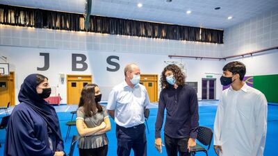 Pupils receive their IB results at Jumeira Baccalaureate School. From left to right are Rawan Khoori, Nour Fraijat, teacher Richard Drew, Harry Sharpe and Mohammed Abdulkarim. Antonie Robertson / The National