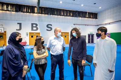 Pupils receive their IB results at Jumeira Baccalaureate School. From left to right are Rawan Khoori, Nour Fraijat, teacher Richard Drew, Harry Sharpe and Mohammed Abdulkarim. Antonie Robertson / The National