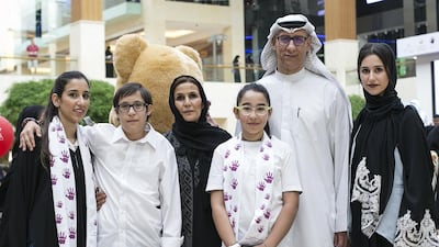 Sharif Al Shami celebrates Down Syndrome Day with his family at Yas Mall. His son, Omar (second left), has Down Syndrome. Mona Al Marzooqi/ The National