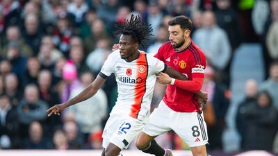 Issa Kabore of Luton Town takes on Bruno Fernandes of Manchester United. EPA