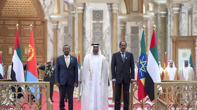 Sheikh Mohamed bin Zayed, Dr Abiy Ahmed, Prime Minister of Ethiopia (left) and Isaias Afwerki, President of Eritrea (right), stand for the UAE national anthem during a reception at the Presidential Palace in July 2018. Hamad Al Kaabi / Crown Prince Court - Abu Dhabi