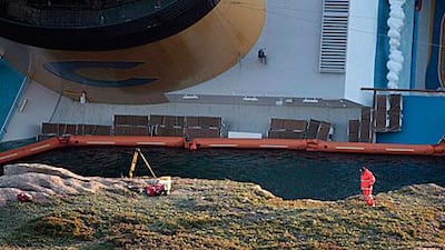 The Costa Concordia lies on its side after running aground. Italian navy divers yesterday exploded holes in the hull of the ship to speed up the search for 29 missing passengers and crew.